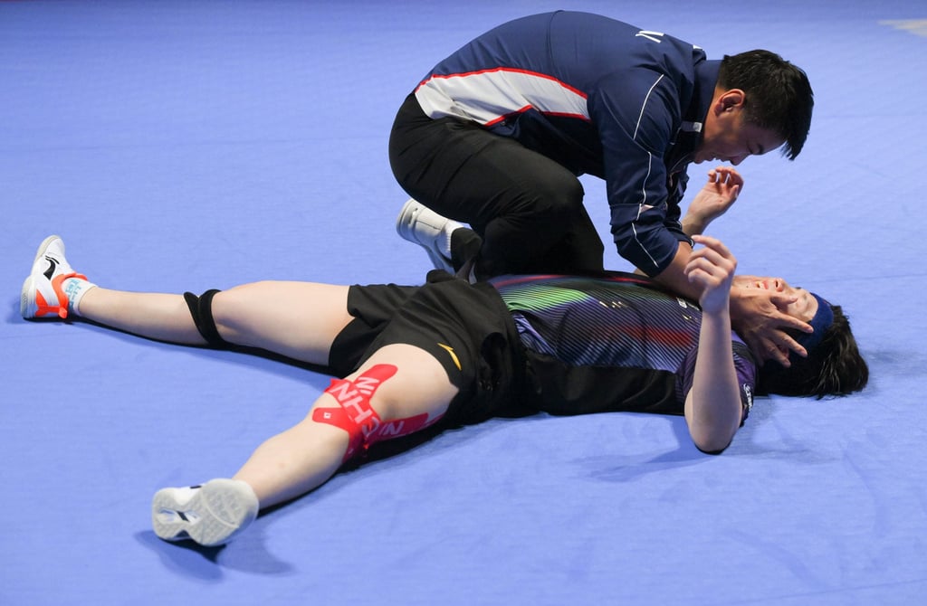 Wang Chuqin celebrates with coach Wang Hao after winning the men's singles. Photo: Xinhua
