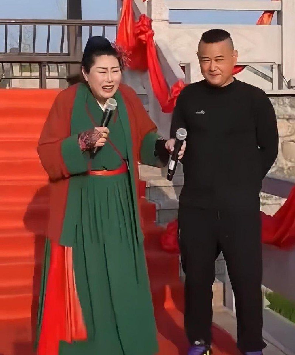 The 51-year-old man on stage with the host of the matchmaking event. Photo: Weibo