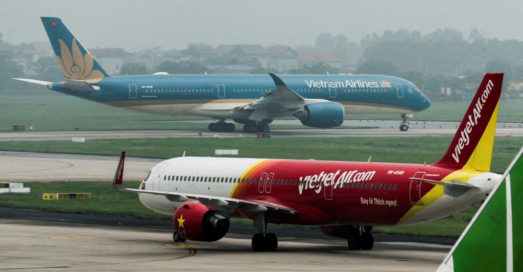 Planes from VietJet and national flag carrier Vietnam Airlines taxi at Noi Bai International Airport in Hanoi on May 28, 2025. Photo: Reuters