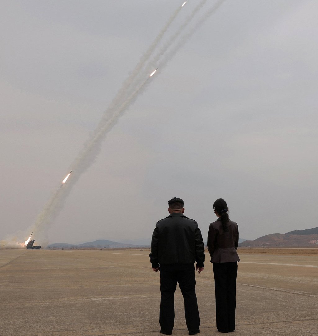North Korean leader Kim Jong-un, accompanied by daughter Ju-ae, oversees the test-launch of 600 mm-calibre multiple rocket launchers on March 14. Photo: KCNA/Reuters North Korean leader Kim Jong-un, accompanied by daughter Ju-ae, oversees the test-launch of 600 mm-calibre multiple rocket launchers on March 14. Photo: KCNA/Reuters