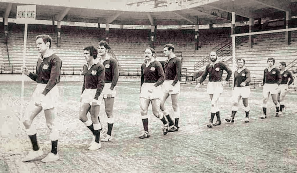 Hong Kong players run out on to the pitch at the first sevens in 1976, Lloyd is the one in front hold the Hong Kong sign. Photo: HKRFU