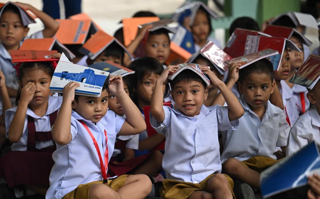 Students place books on their heads during an earthquake drill in Manila in September 2025. Photo: AFP Students place books on their heads during an earthquake drill in Manila in September 2025. Photo: AFP
