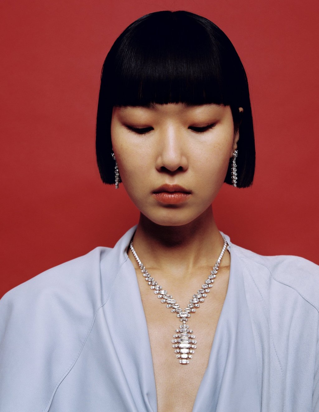 Earrings, necklace: Cartier. Trench coat: Sportmax