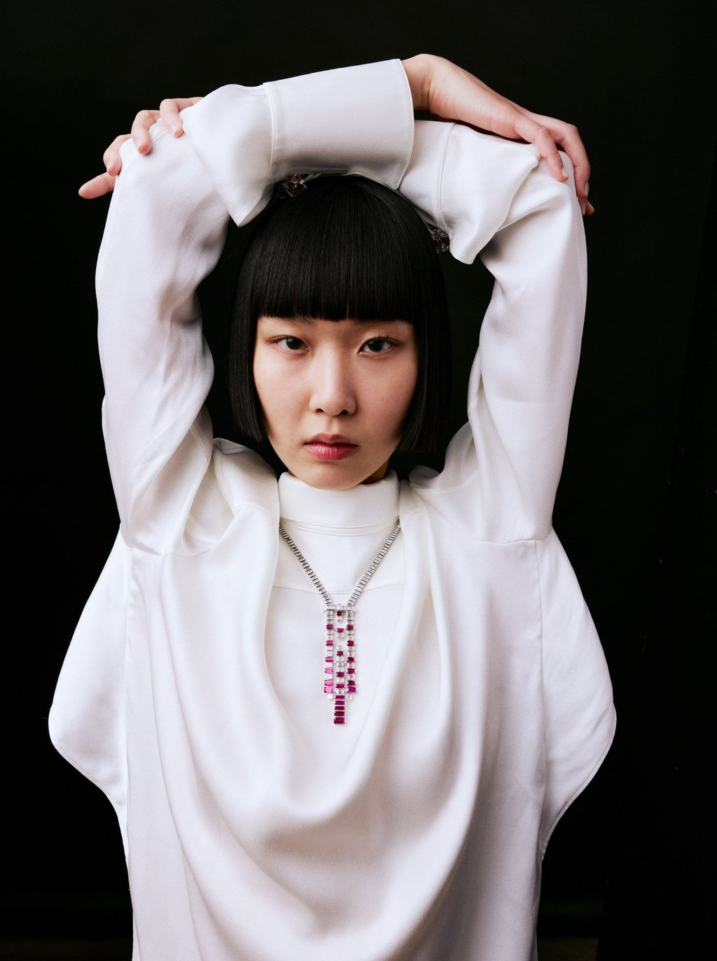 Necklace: Cartier. Blouse: Louis Vuitton