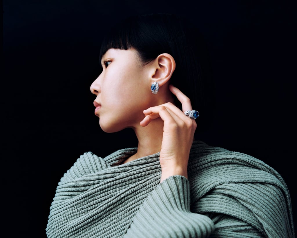 Earring, ring: Cartier. Cape, jumper: Balmain