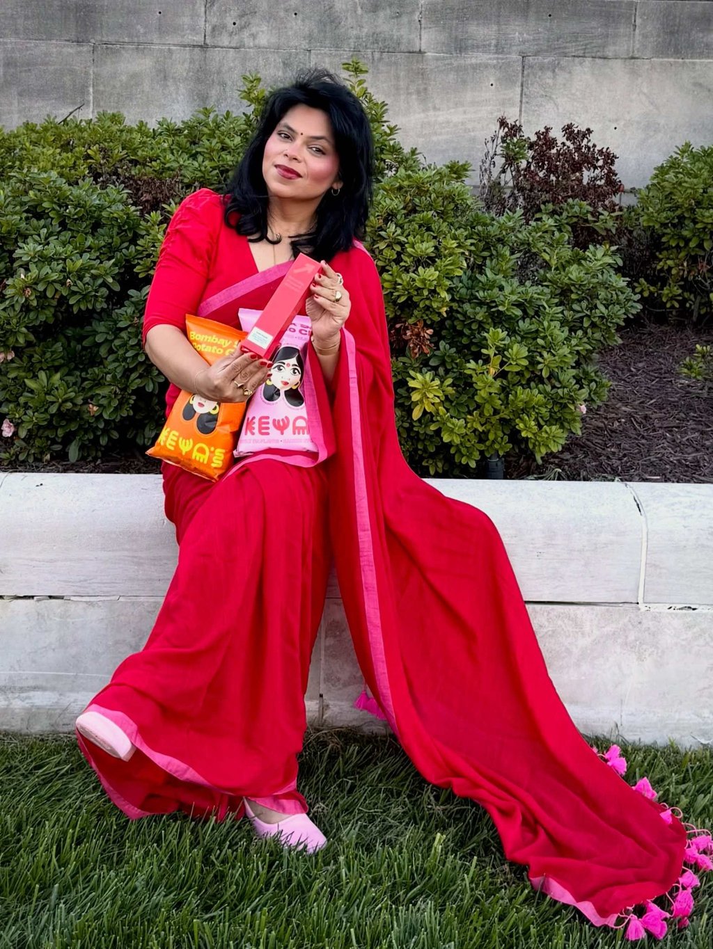 Wingfield holds bags of Keya’s Snacks crisps in an Instagram post from 2025. Photo: Instagram/keyaandco