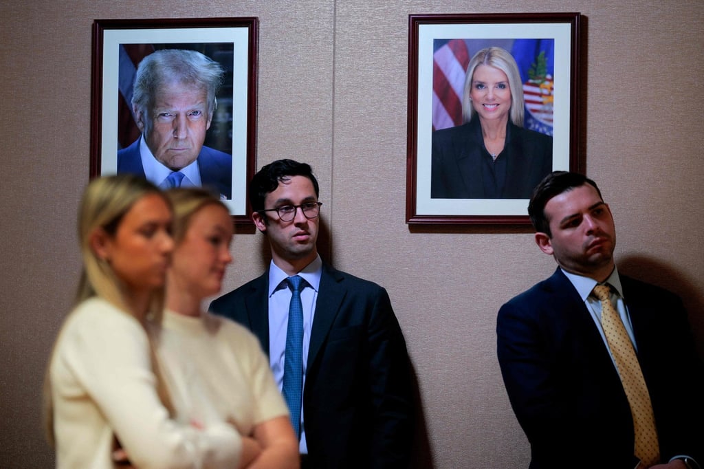 Official portraits of US President Donald Trump and former attorney general Pam Bondi hang on the wall during a news conference in Washington on Tuesday. Photo: AFP