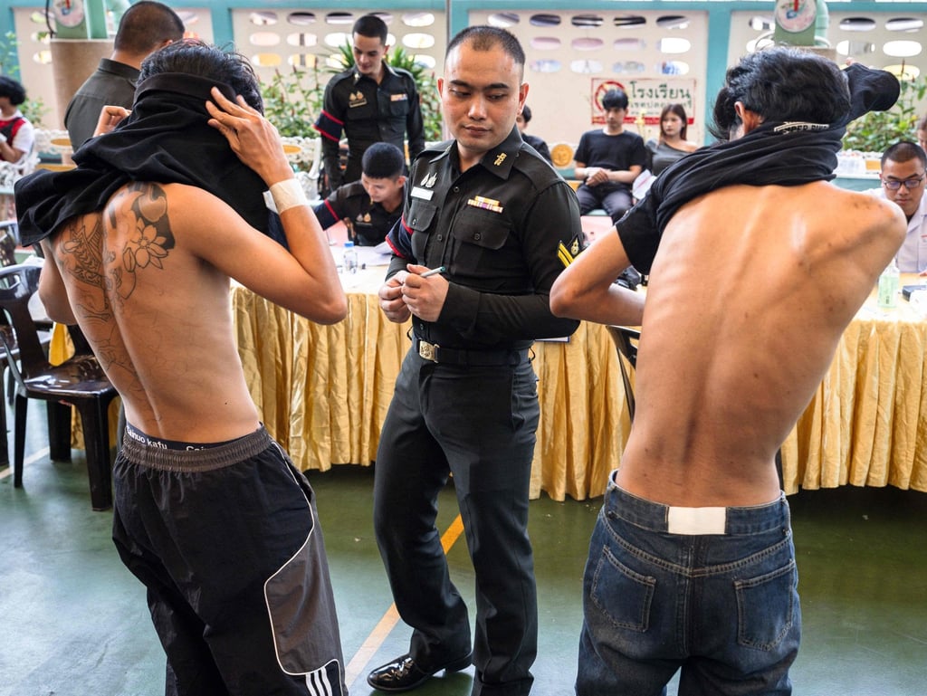 Men receive a medical examination before drawing their ballots for the Thai military conscription lottery in Bangkok on Tuesday. Photo: AFP