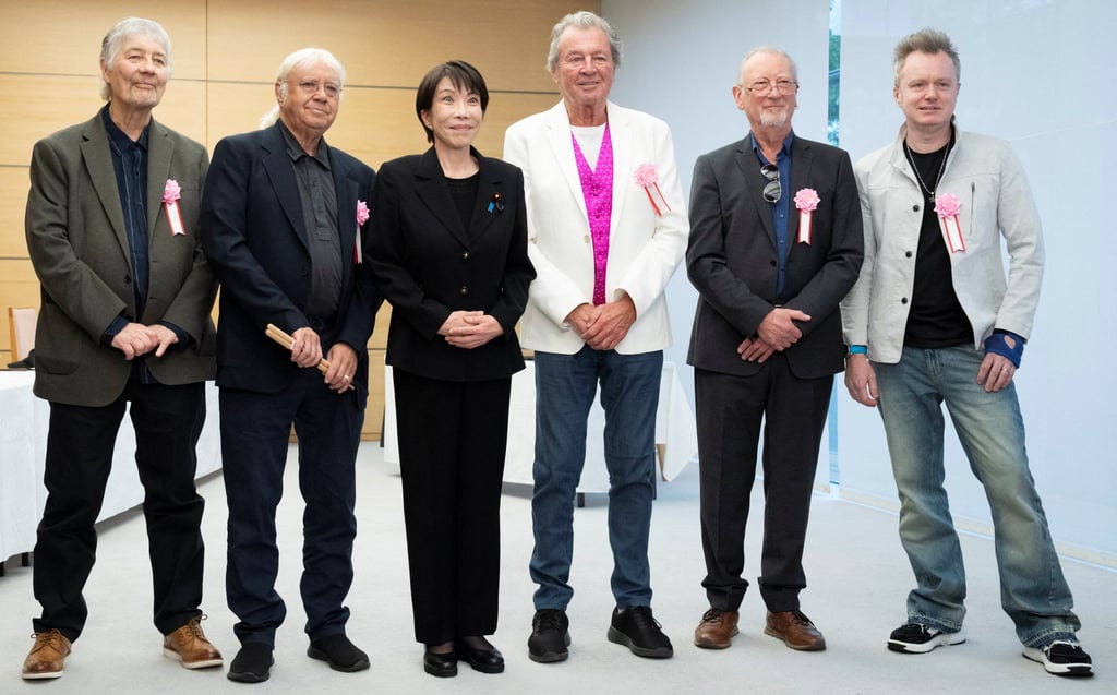 Japanese Prime Minister Sanae Takaichi poses with members of British rock band Deep Purple at the Prime Minister’s Office in Tokyo on Friday. Photo: Reuters