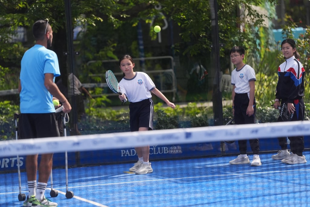 Primary school pupils try padel, a hybrid of tennis and squash, with a coach in Go Park Sai Sha on March 18. Photo: Elson Li