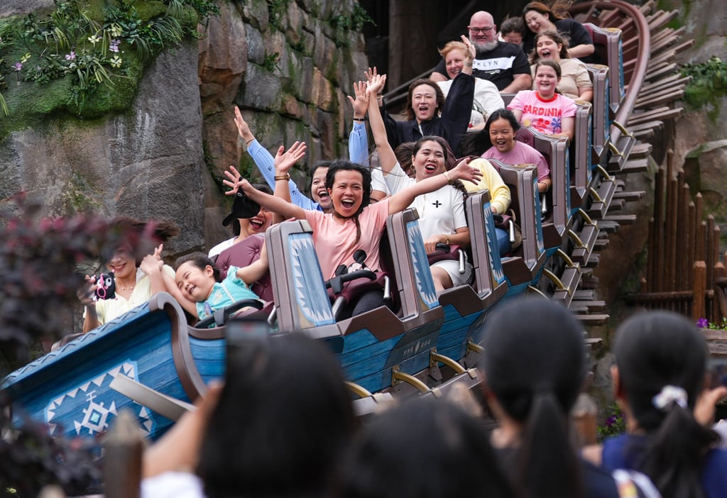 Domestic helpers enjoy a ride at the amusement park. Photo: Eugene Lee