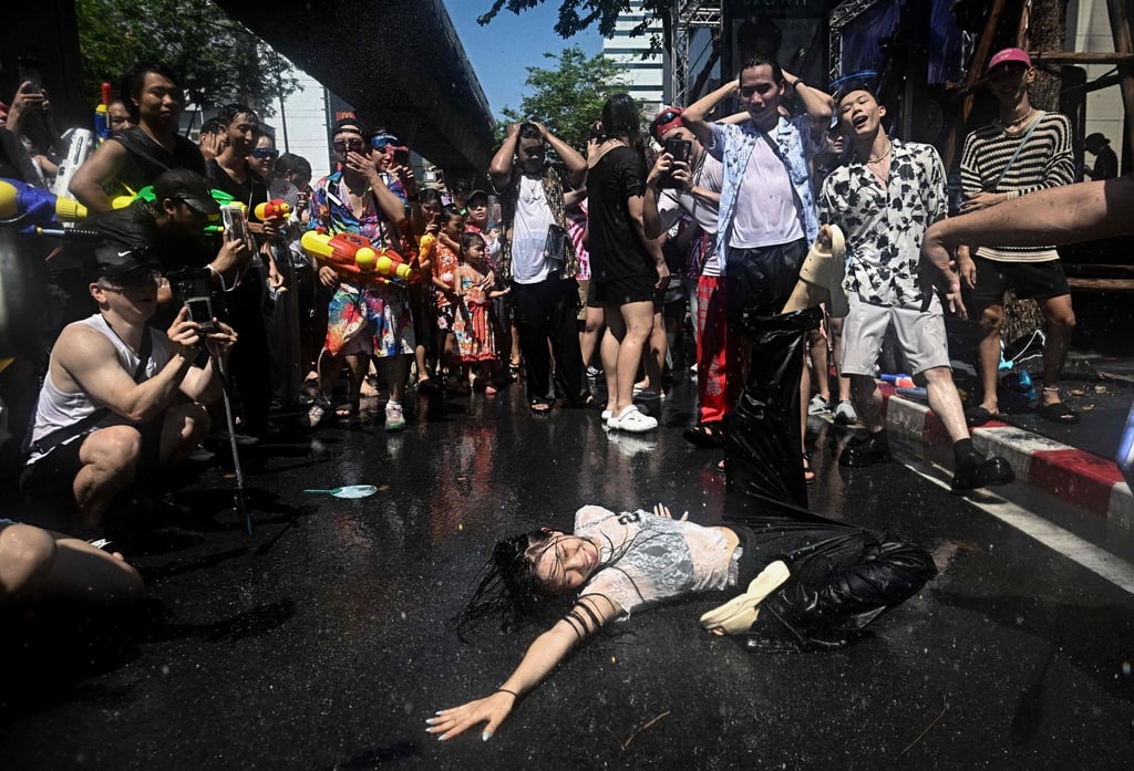 Revellers in Silom Road, Bangkok, dance on the street on Sunday, the eve of the Songkran. Photo: AFP