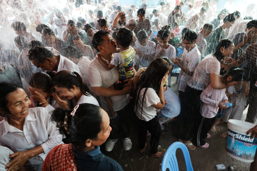 Residents of a village on the outskirts of Phnom Penh, Cambodia, receive a holy water shower believed to bring good luck during Choul Chnam Thmey celebrations on Sunday. Photo: AP