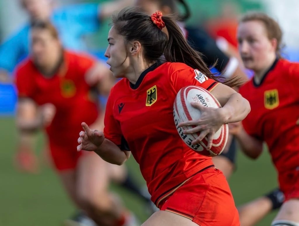 Fella plays for the German women’s rugby team while wearing a Cheongsam-inspired scrunchie she designed herself.