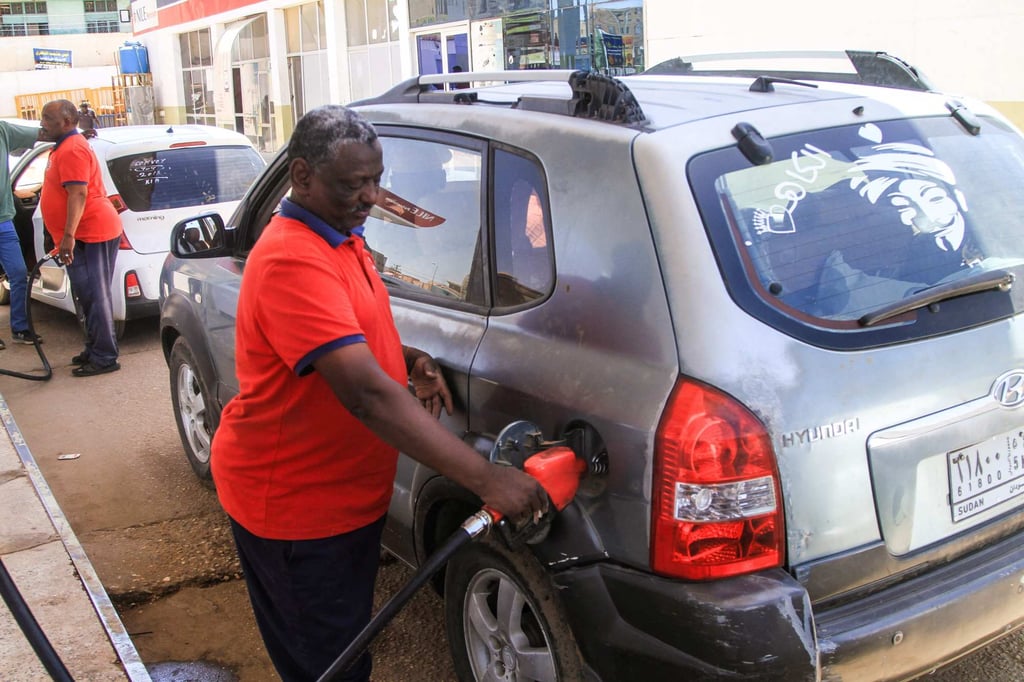 A petrol attendant fills a car’s tank at a petrol station amid a fuel crisis and soaring petrol prices in Omdurman, north of Sudan’s capital Khartoum, on Sunday. Photo: AFP A petrol attendant fills a car’s tank at a petrol station amid a fuel crisis and soaring petrol prices in Omdurman, north of Sudan’s capital Khartoum, on Sunday. Photo: AFP