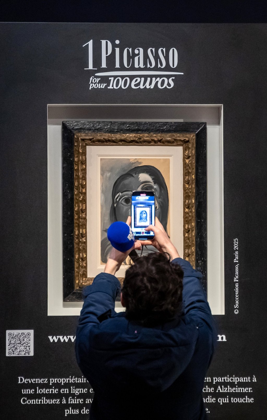 A person takes pictures during the ‘1 Picasso for 100 euros’ charity raffle in Paris, France, on Tuesday. Photo: EPA