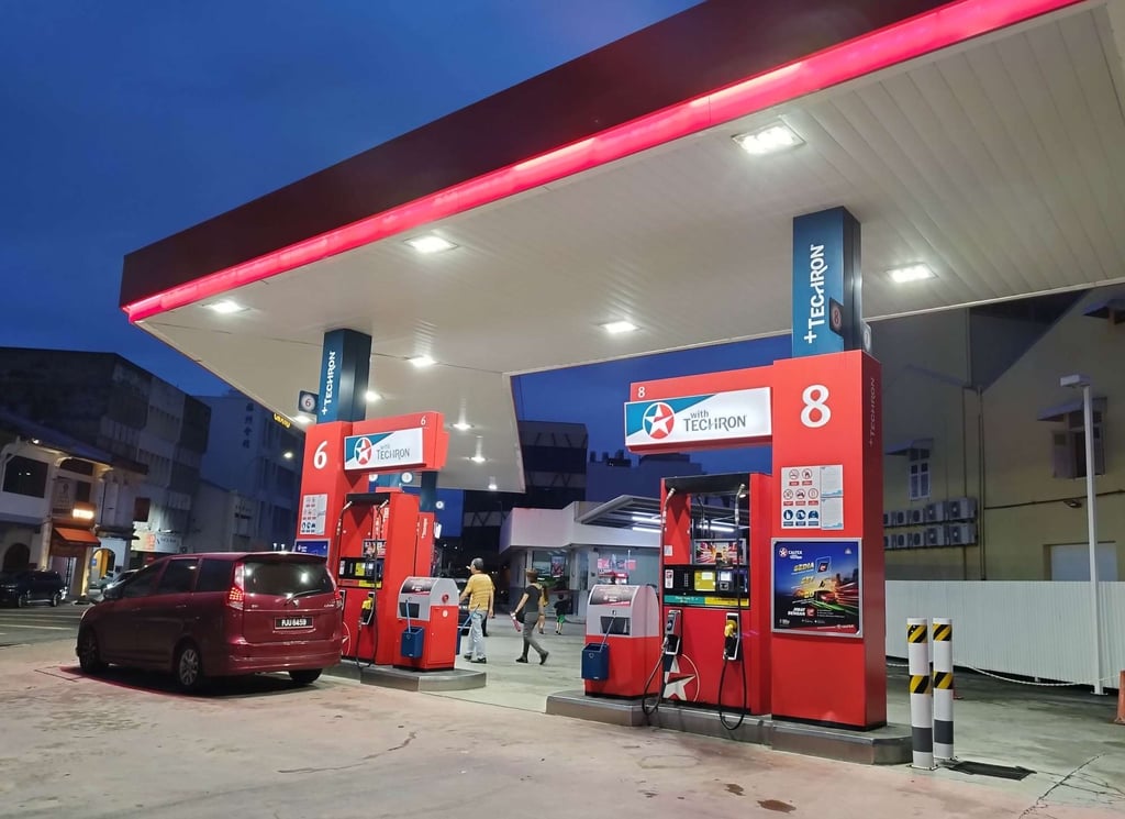Cars park at pumps at a petrol station in Malaysia. Photo: Ivy Ong