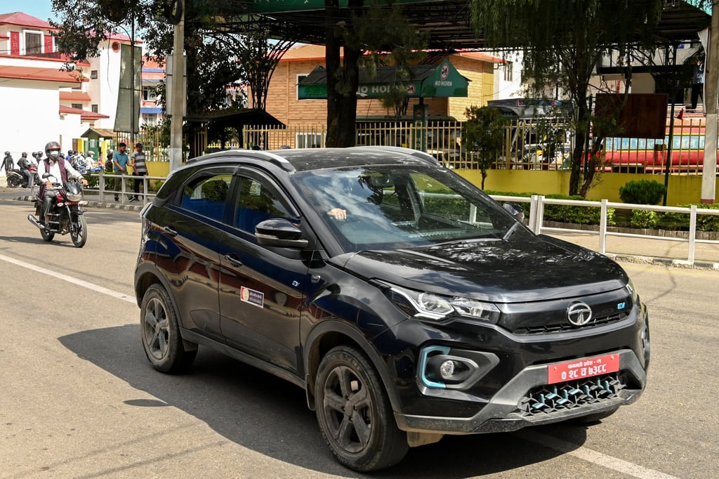 A man drives a Tata EV along a street in Kathmandu. Electric cars now account for more than 70 per cent of new vehicle sales in Nepal. Photo: AFP