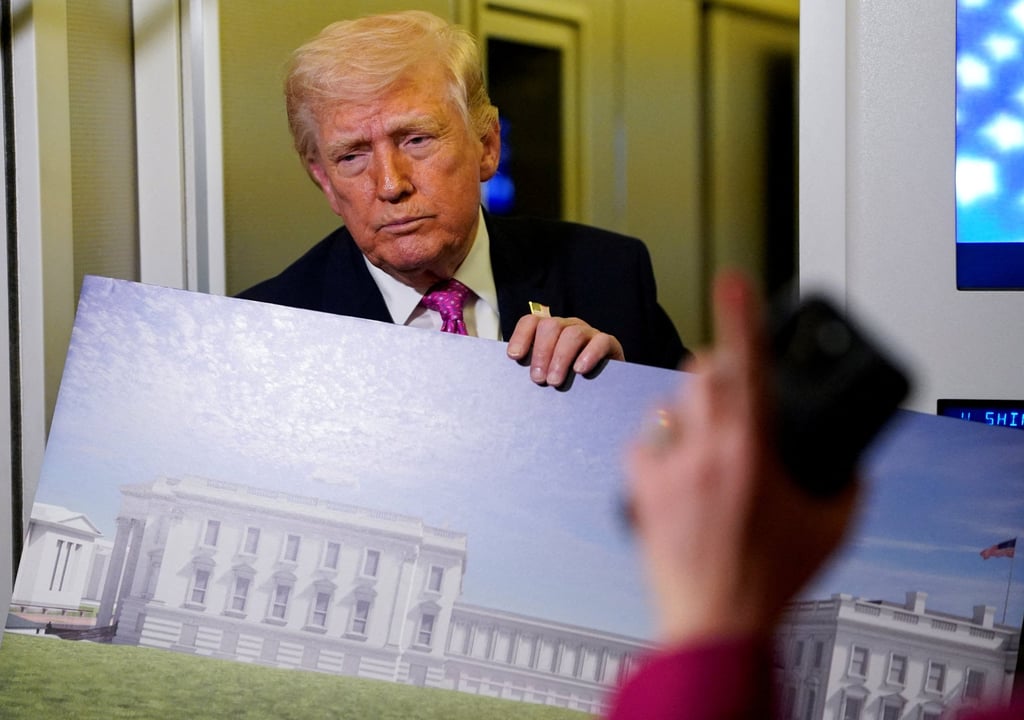 US President Donald Trump holds up a rendering of the planned White House ballroom aboard Air Force One on March 29. Photo: Reuters