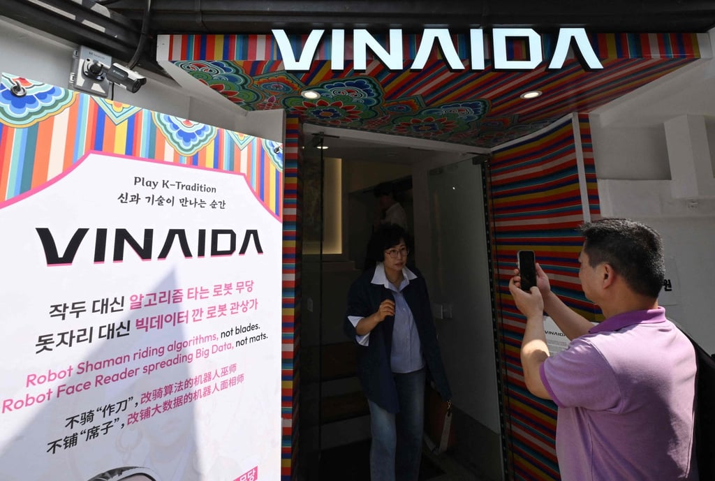 Visitors take photos in front of a Korean shamanism theme shop in Seoul on Wednesday. Photo: AFP