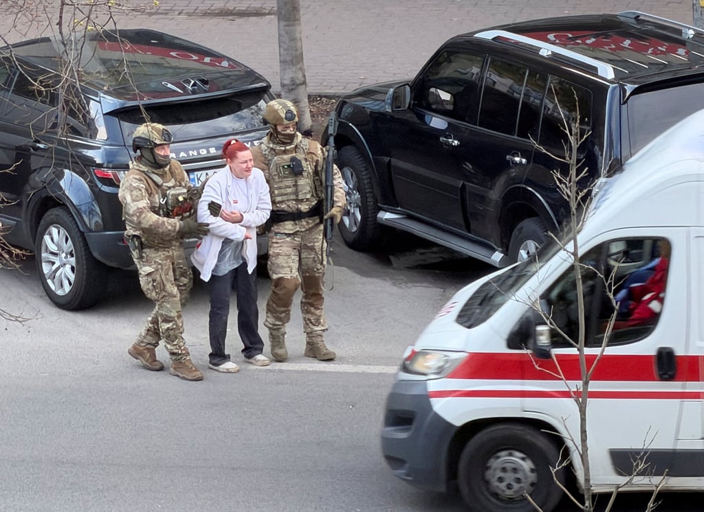 Special forces officers evacuate a hostage at the site of a shooting incident, in Kyiv, Ukraine, on Saturday. Photo: Reuters