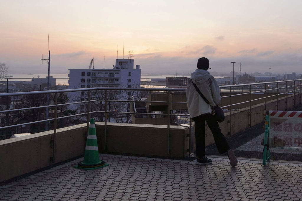 A local resident in Kushiro on Hokkaido, Japan’s northernmost main island, evacuates to a higher place after a tsunami warning was issued following an earthquake on Monday. Photo: Reuters