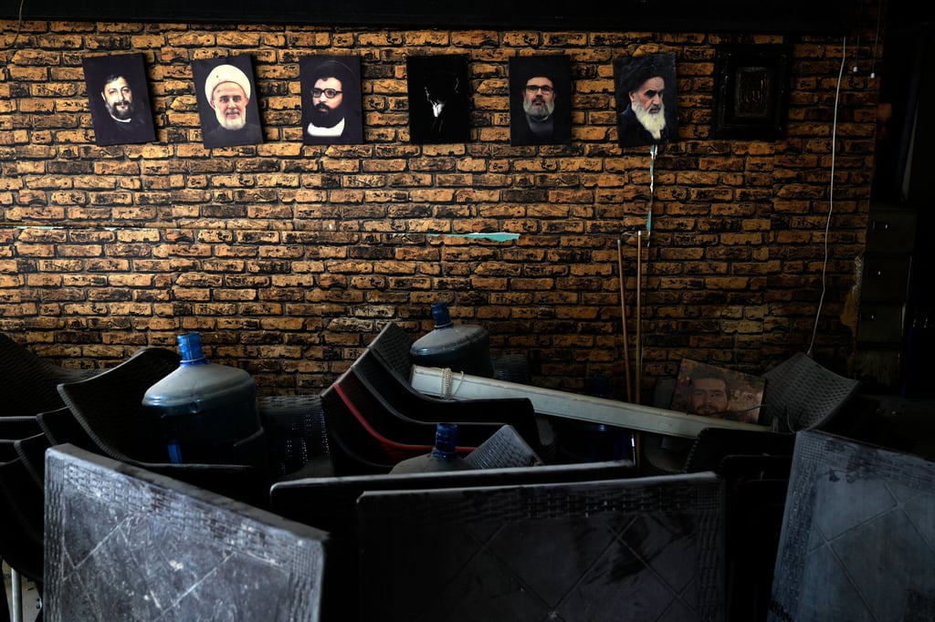 Portraits of late Hezbollah leaders, including the late Iranian revolutionary founder Ayatollah Khomeini, right, hang on the wall of a damaged coffee shop in Dahiyeh, Beirut’s southern suburbs. Photo: AP