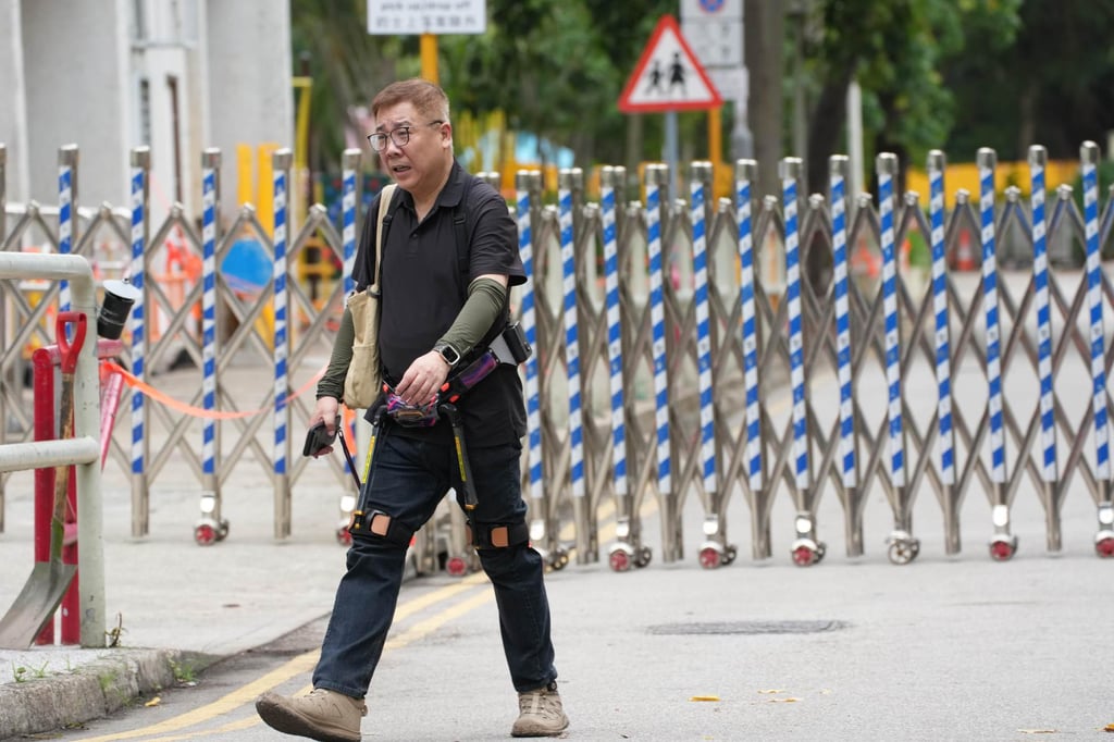 Resident Tam, 55, used an exoskeleton to aid his climb up to his 17th floor flat. Photo: Jelly Tse