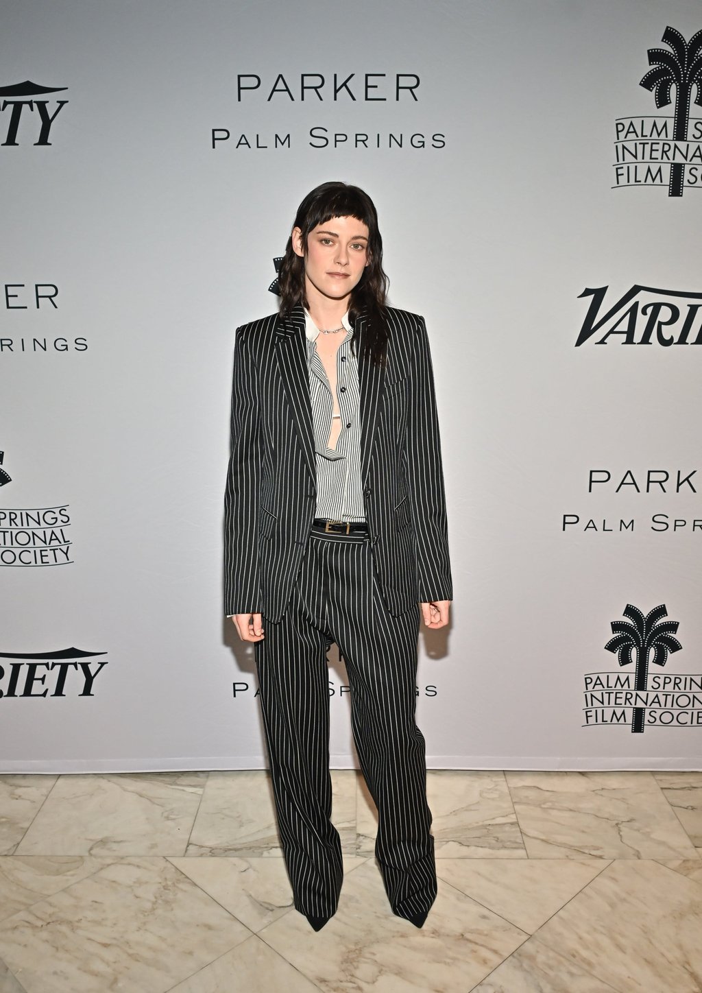 Kristen Stewart wears a Tom Ford by Haider Ackermann pinstripe suit to the Creative Impact Awards. Photo: Variety via Getty Images