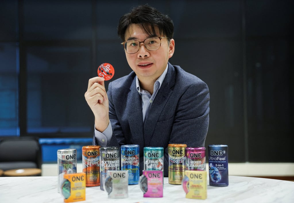 CEO of condom manufacturer Karex, Goh Miah Kiat, poses with condoms made by the company in Petaling Jaya, Malaysia, on Tuesday. Photo: Reuters
