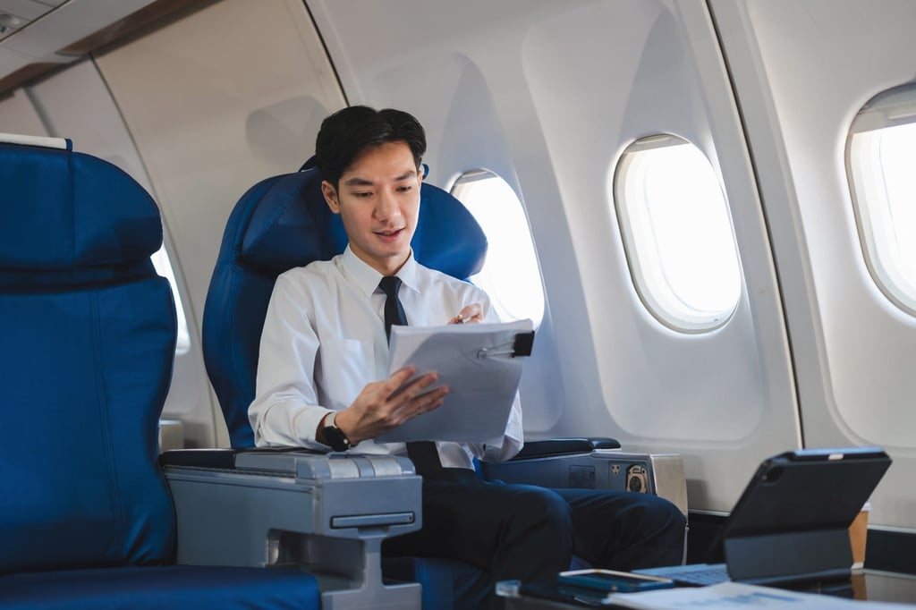 A wealthy young businessman gets down to work on an aircraft. Photo: Shutterstock