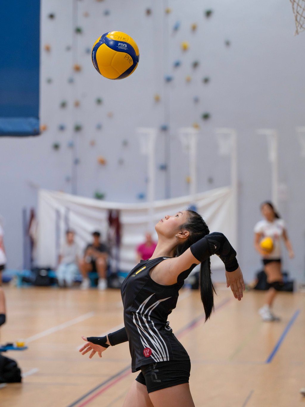 A student serves during a volleyball match at Renaissance College. Photo: Handout