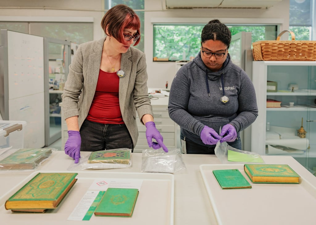 Melissa Tedone (left) and art conservation graduate Brittany Murray place Victorian-era emerald-green bookbindings in protective casing at the Winterthur Museum, Garden and Library in Wilmington, Delaware. Photo: Getty Images