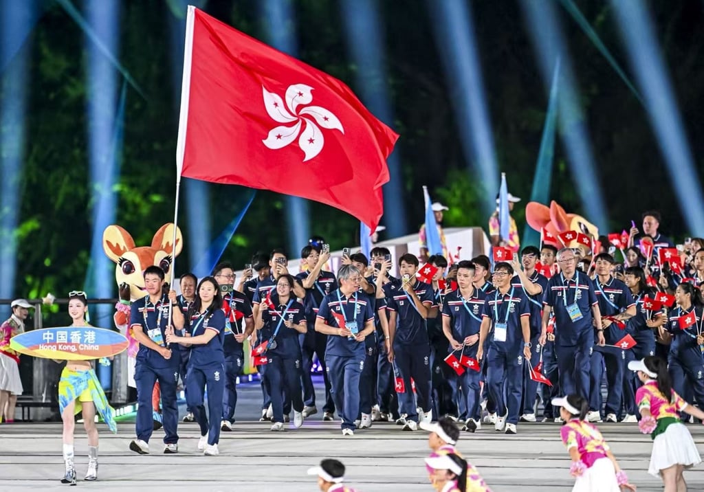 Curtis Ho (left) and Nip Tsz-yin carrying the Hong Kong flag at the opening ceremony on Wednesday. Photo: SF&OC