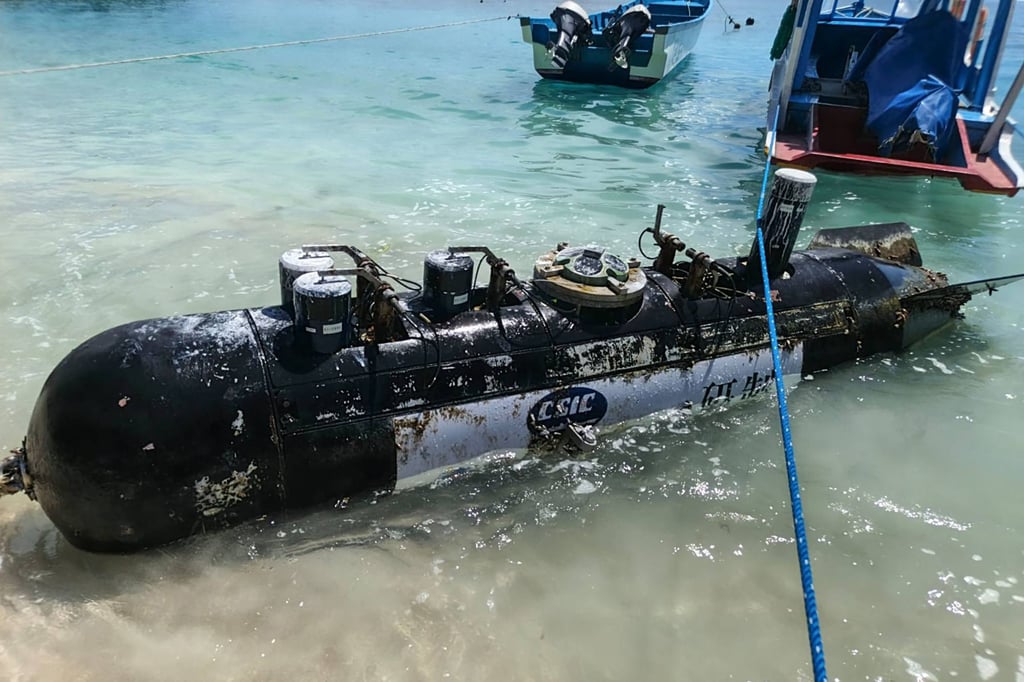 A torpedo-like object, discovered by a fisherman near the Lombok Strait, after being towed ashore onto a beach in West Nusa Tenggara, Indonesia, on April 6. Photo: AFP