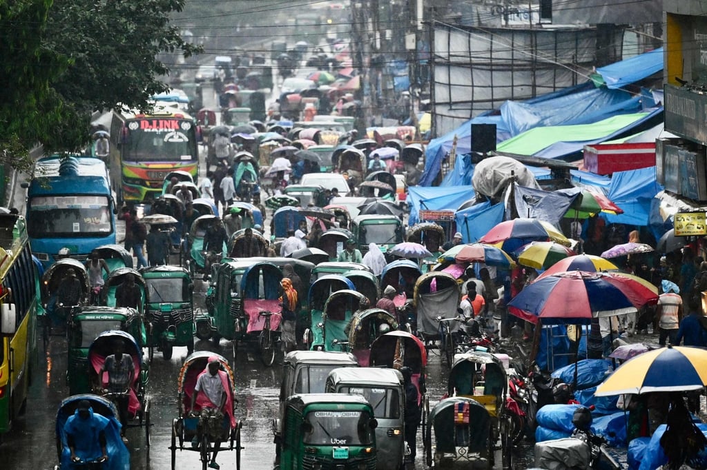 Vehicles make their way along a busy road during a rainfall in Dhaka. Photo: AFP