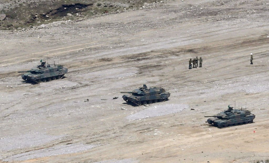 A Japanese Ground Self-Defence Force Type 10 tank (centre) is seen during a live‑fire drill at the Hijudai manoeuvre area on April 21, 2026. Photo: Kyodo