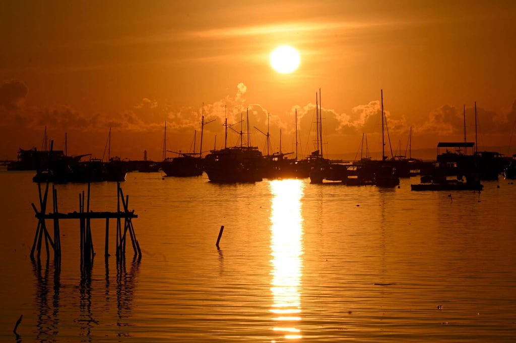 The sun rises behind boats moored at a pier on Indonesia’s resort island of Bali on April 12. Bali recorded 547 earthquakes last year. Photo: AFP