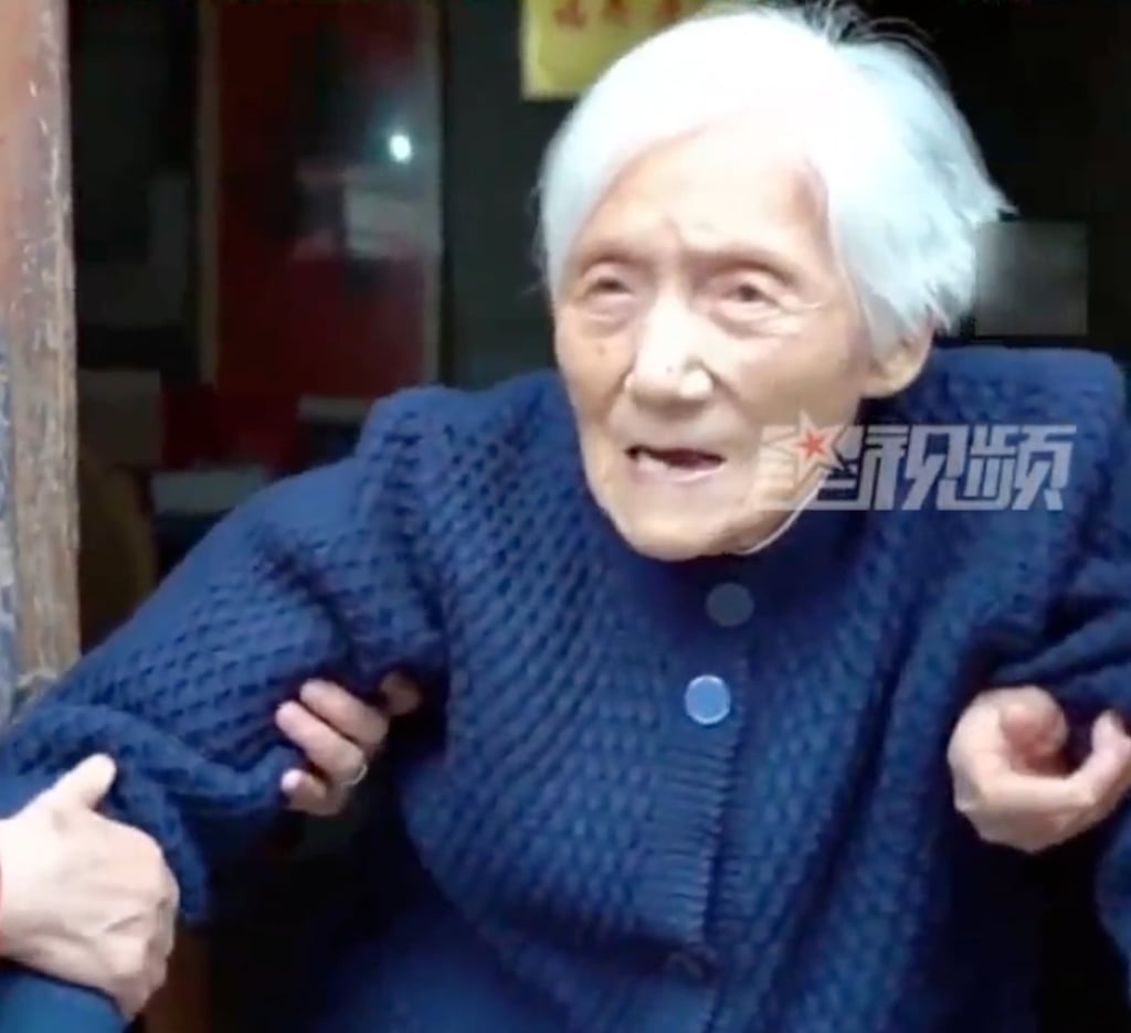 Ding Guijuan, above, can still get around on her feet, albeit with a little help. Photo: Baidu