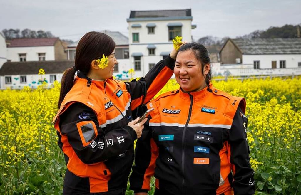 Two of the women, above, take a break from delivery duties to have some fun. Photo: Photo: Xie HaiLong