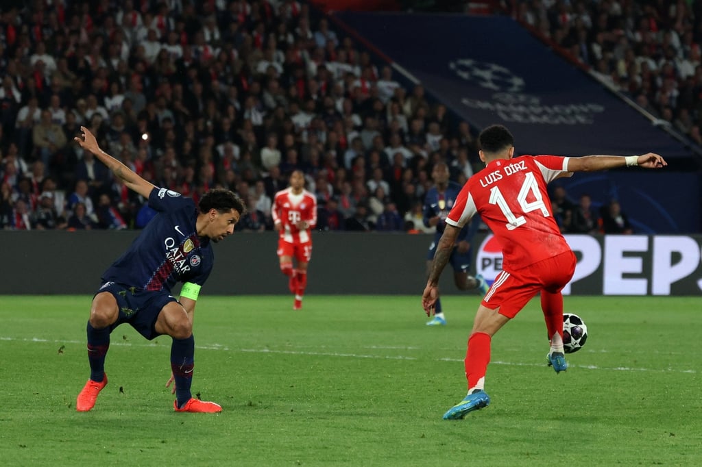 Bayern Munich’s Luis Diaz (right) about to shoot past Vitinha of PSG for his team’s fourth goal. Photo: EPA