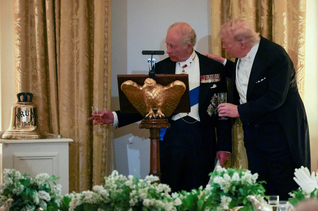 Britain’s King Charles presents a bell to US President Donald Trump as a gift during a state dinner for the king and Queen Camilla, at the White House on April 28. Photo: Reuters
