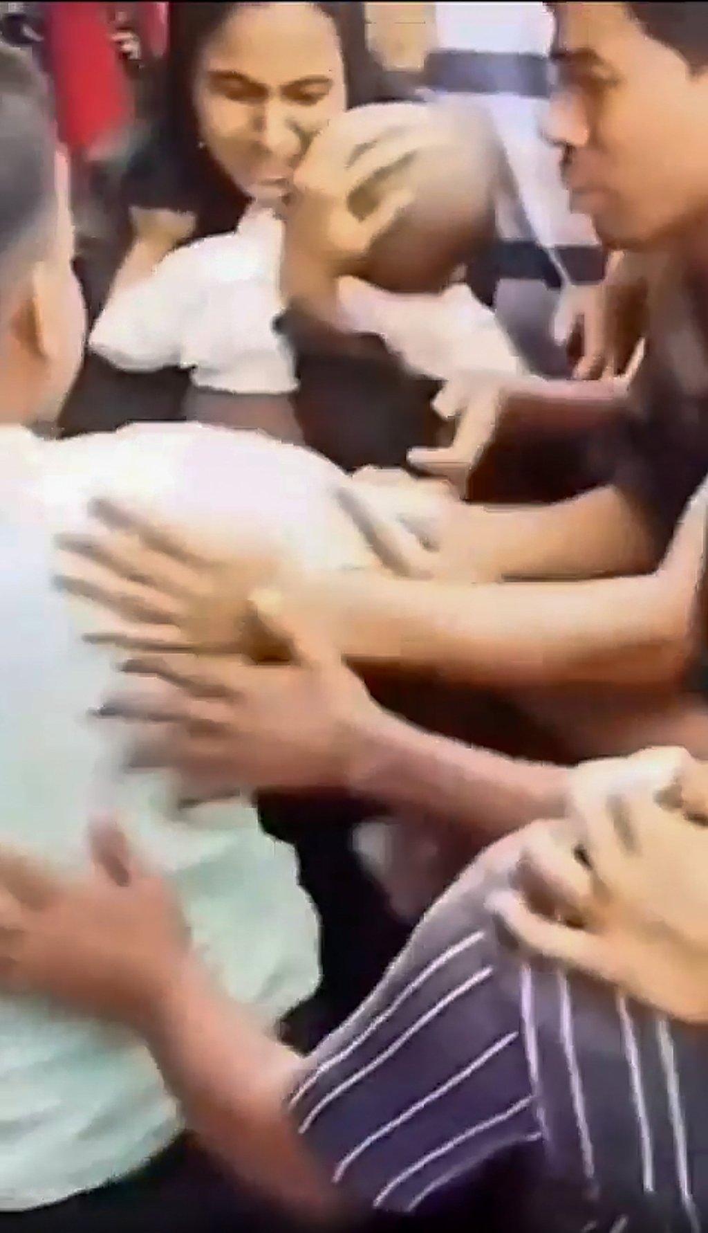 The baby’s mother is seen cuddling her child after the rescue. Photo: Handout