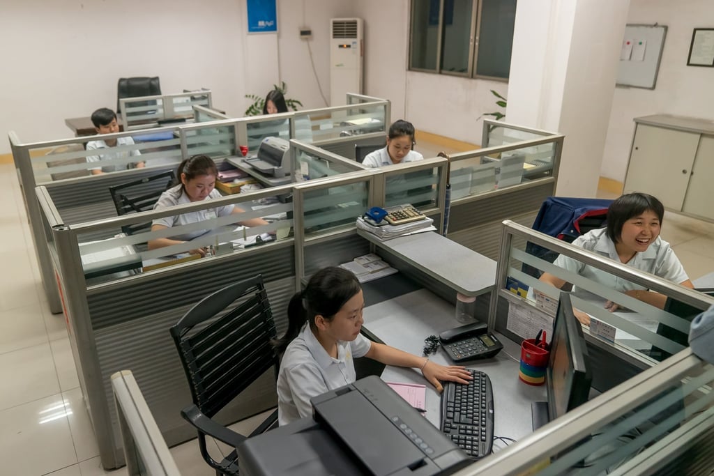 Chinese staff working in an office in the city of Dongguan in the southern province of Guangdong. Photo: Shutterstock