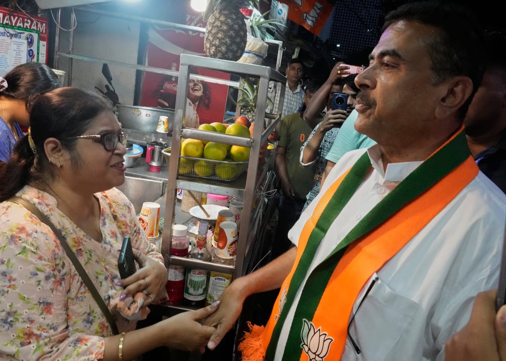 Suvendu Adhikari (right) meets people during a campaign rally in Kolkata on April 22. Photo: AP