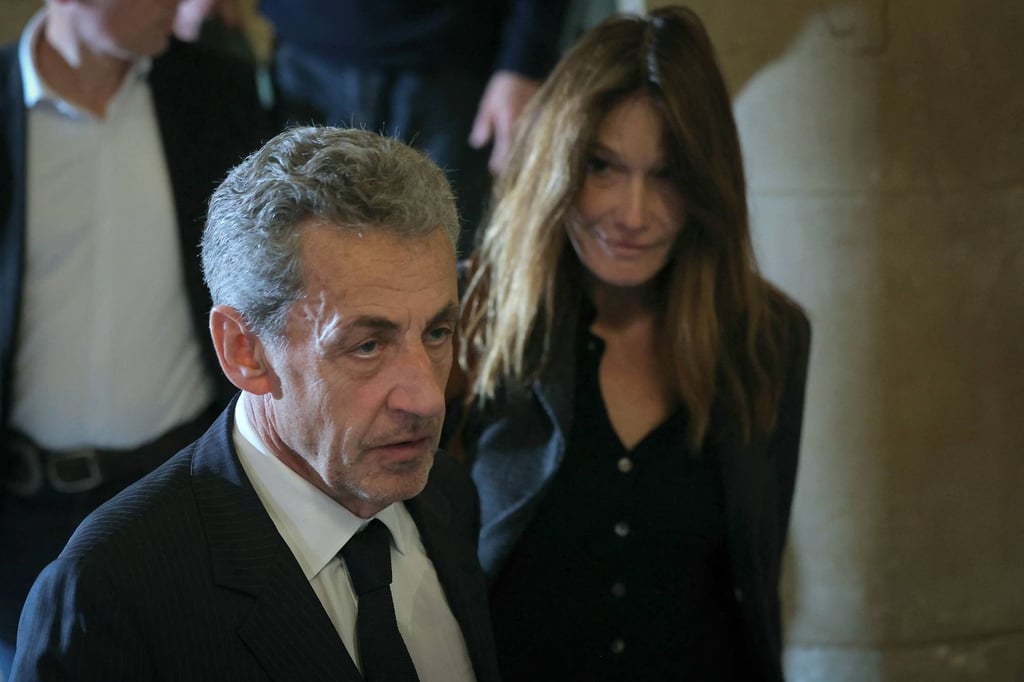 Former France’s President Nicolas Sarkozy (left) and his wife Carla Bruni leave the courtroom at the Palais de Justice courthouse in Paris on April 7. Photo: AFP