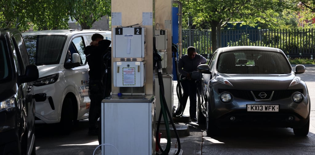 Customers fill their tanks at a petrol station in London on April 22. Photo: EPA