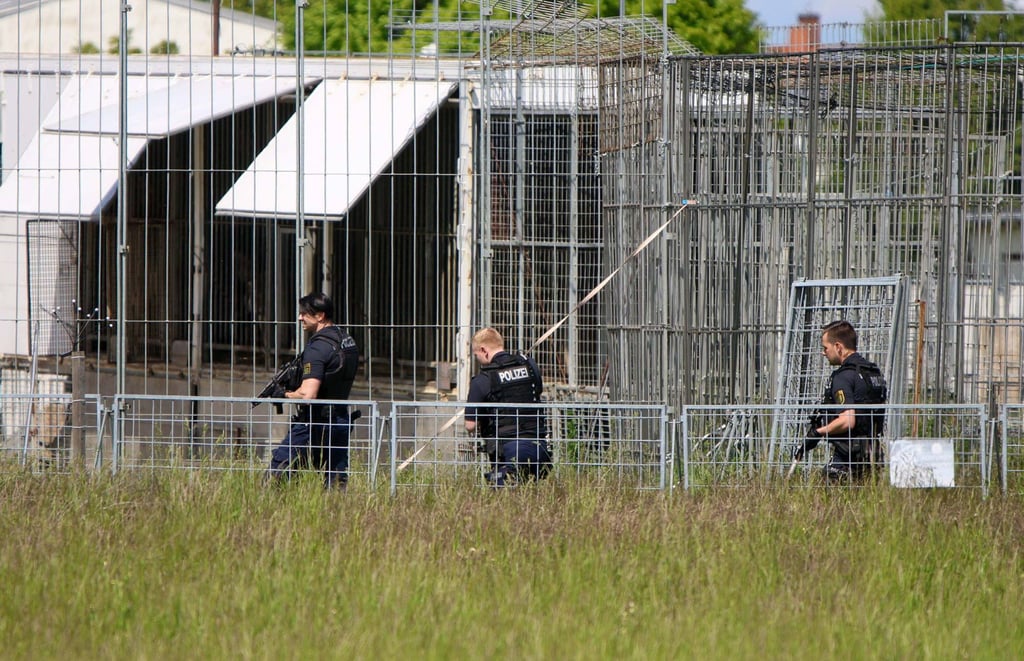 Heavily armed police at the facility for caged big cats. Photo: dpa Heavily armed police at the facility for caged big cats. Photo: dpa