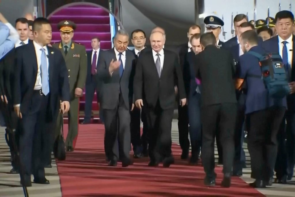 Russian President Vladimir Putin (centre right) is escorted by Chinese Foreign Minister Wang Yi after arriving in Beijing on Tuesday for a two-day visit. Photo: Russian Pool