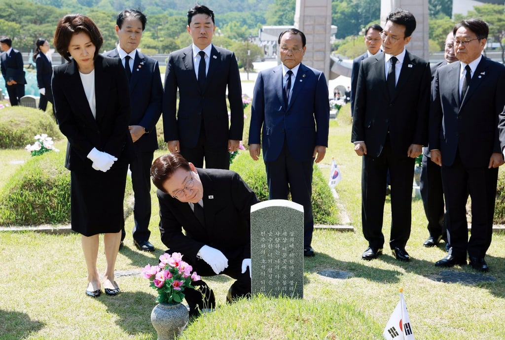 South Korean President Lee Jae Myung (front) visits the tomb of a pro‑democracy activist at the May 18 National Cemetery in Gwangju on Monday. Photo: EPA/Yonhap South Korean President Lee Jae Myung (front) visits the tomb of a pro‑democracy activist at the May 18 National Cemetery in Gwangju on Monday. Photo: EPA/Yonhap